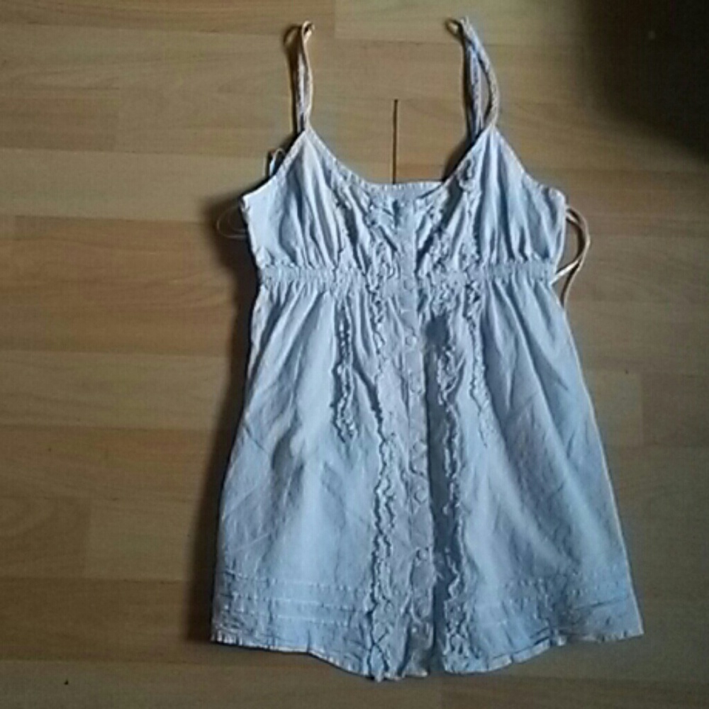 A tan tank top with buttons cream color